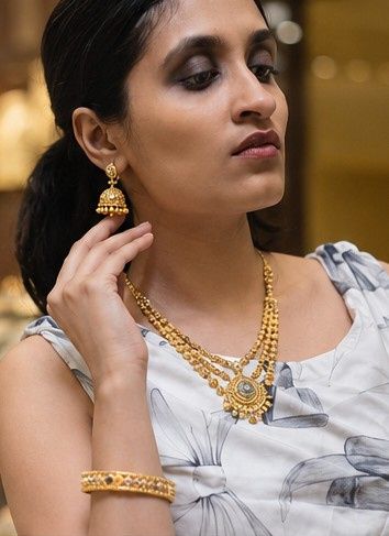 Thejaswini in a temple jhumka and layered kasumala — Balakrishna Jewellery, Stadium, Palakkad
