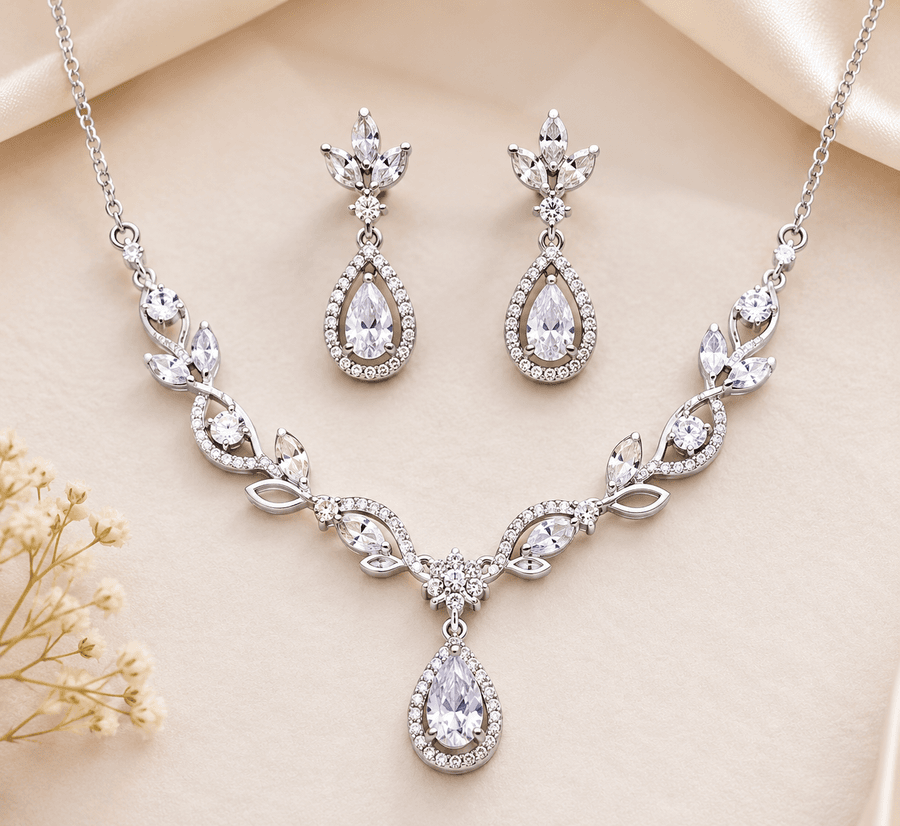 A silver bridal necklace and matching drop earrings, stone-set with pear-cut cubic zirconia